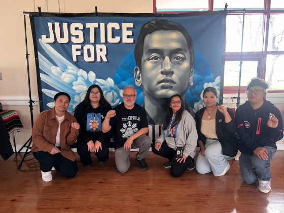 Six individuals kneeling in front of the Justice for Angelo Quinto Poster